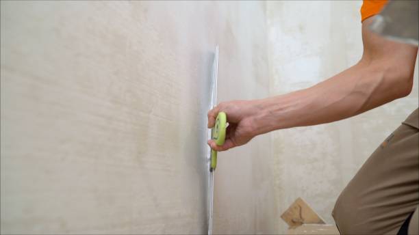 istock Worker plastering the walls with a spatula. work aligns with a spatula 1682449893