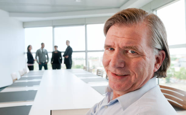 istock smiling businessman in modern board room 168246442