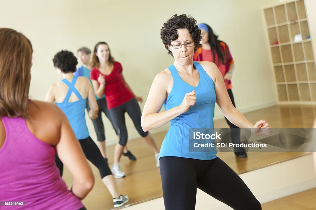 Fitness instructor dancing while leading class Fitness instructor dancing while leading class.   Zumba Stock Photo
