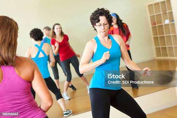 Fitness Instructor Dancing While Leading Class Stock Photo - Download Image Now - Zumba, Dancing, Gym