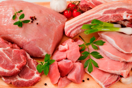 Various cuts of pork meat on a chopping board