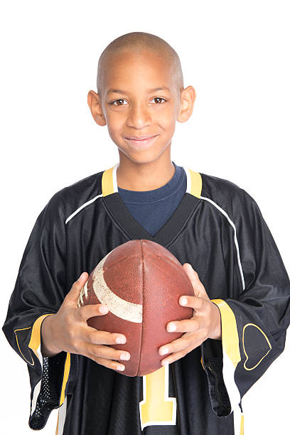 istock Young boy holding a football and looking at camera. 168246637
