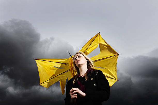 istock Gimme shelter! Sad blonde with broken umbrella in thunderstorm 168247017