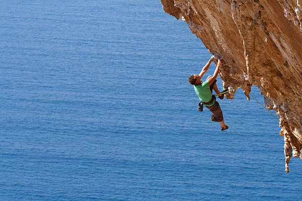 istock A man climbing on a rocky mountain with harness 168247617