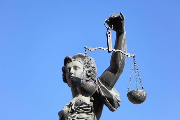istock side portrait of Lady Justice against blue sky 168247618