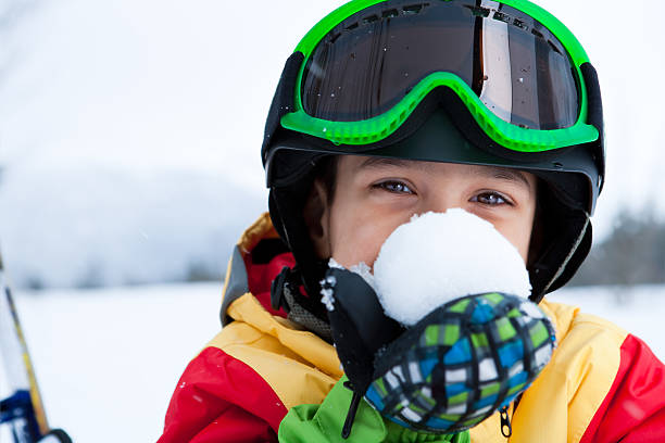 istock Young boy snowboarder holding snowball 168248971