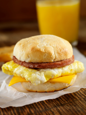 Sausage, Egg and Cheese Breakfast Sandwich on a Buttermilk Biscuit with Hash Browns and Orange Juice- Photographed on Hasselblad H3D2-39mb Camera