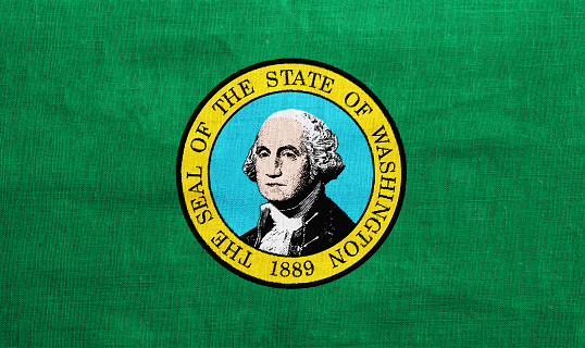 Flag of US state of Washington on a textured background. Concept collage.