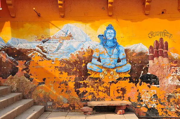 Telephoto image of 1930's old worn mural of Shiva on the holiest Dasashvamedha ghat .