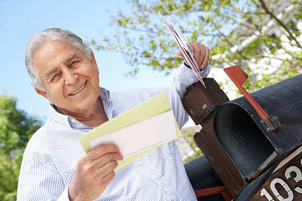 Senior Hispanic Man Checking Mailbox Senior Hispanic Man Checking Mailbox Holding Mail and Smiling at Camera mailbox photos stock pictures, royalty-free photos & images