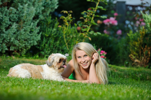 blond woman with her dog in nature.