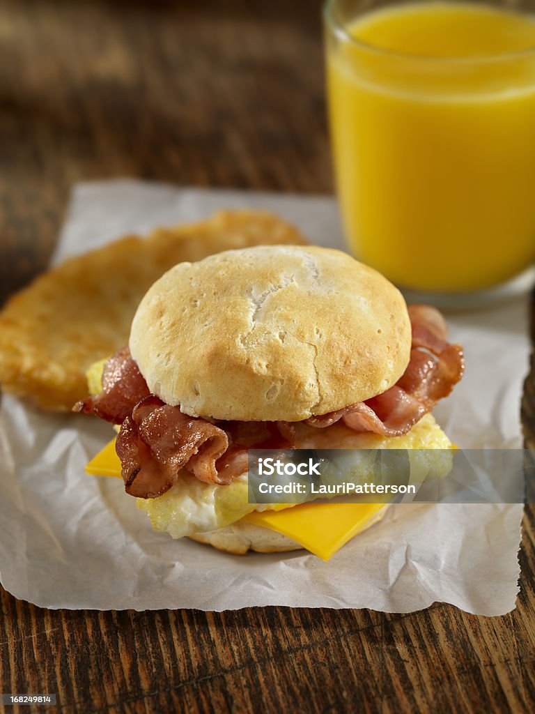 Bacon and Egg Breakfast Sandwich Bacon, Egg and Cheese Breakfast Sandwich on a Toasted English Muffin with Hash Browns and Orange Juice- Photographed on Hasselblad H3D2-39mb Camera American Culture Stock Photo