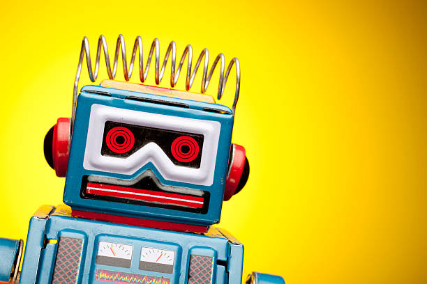 Retro tin robot portrait on yellow