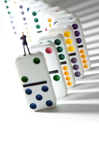 Businessman standing on row of dominos.