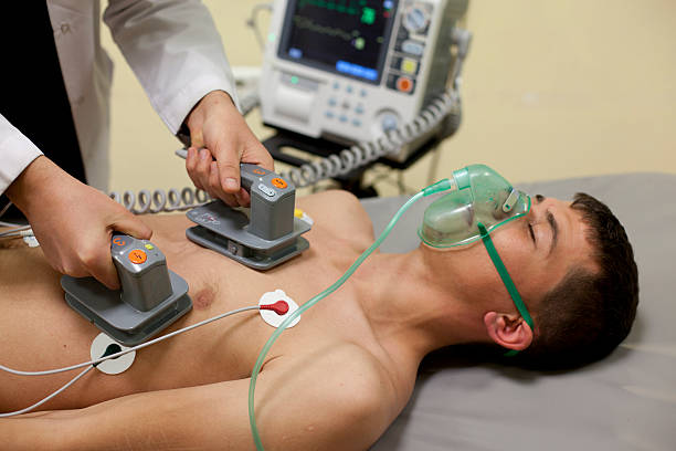 Cardiac massage being oven to patient cardiac massage defibrillator photos stock pictures, royalty-free photos & images