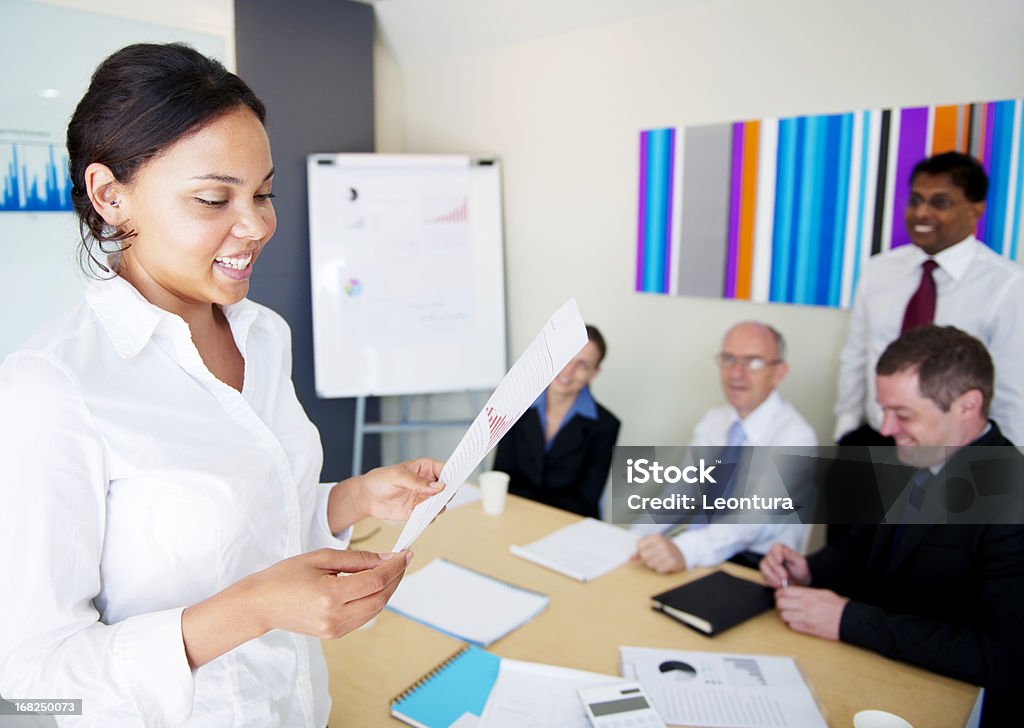 Happy at Work Young lady enjoying her work. Multiracial Group Stock Photo
