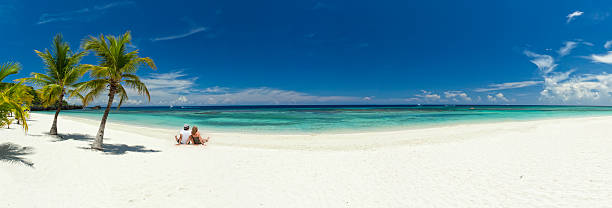 Young couple relaxing on beach stock photo