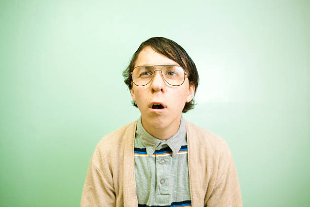 Confused Nerd Guy A confused nerdy student looks up with a perplexed look. ugliness photos stock pictures, royalty-free photos & images