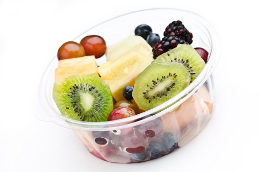 Plastic Tray of assorted fruits on white background