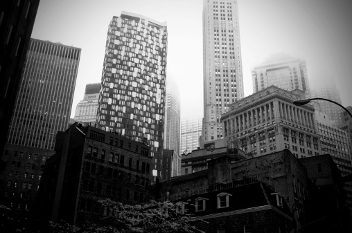 Manhattan Financial District in the fog.Toned,grained and vignette.