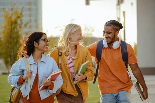 istock Cheerful students walking together on the street 1682529265