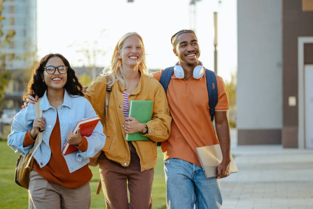 istock Cheerful students walking together on the street 1682531520