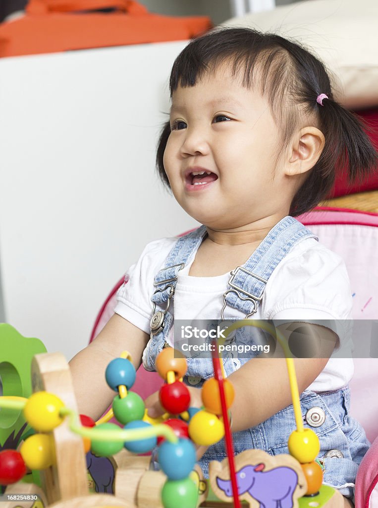 baby playing baby playing colorful wood toys Asian and Indian Ethnicities Stock Photo