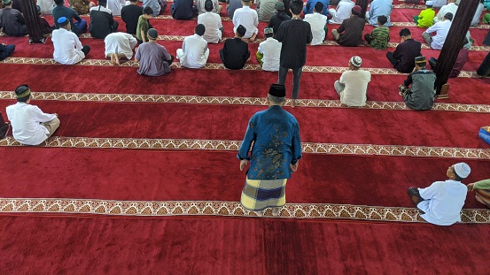 Sambas, West Kalimantan, Indonesia-15 September 2023 : people praying together inside the mosque in sambas