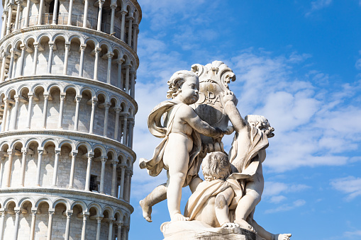 Pisa, Italy - Famous Leaning Tower landmark with blue sky, Renaissance white marble