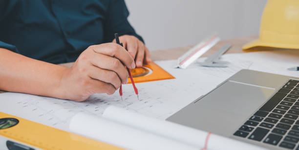 istock engineer working in office with blueprints, inspection in workplace for architectural plan, construction project ,Business construction 1682578759