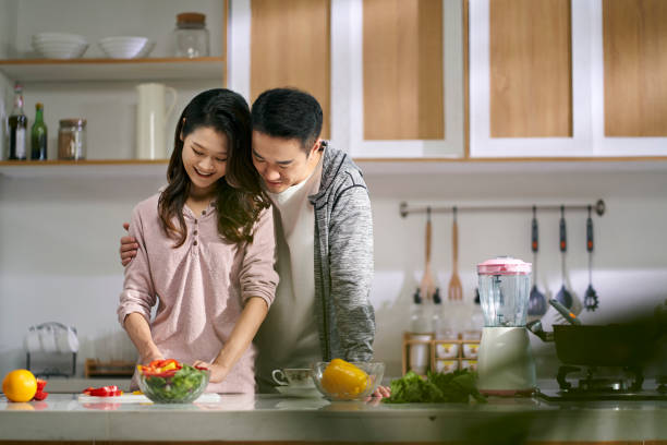 istock young asian couple preparing meal in kitchen at home 1682579431