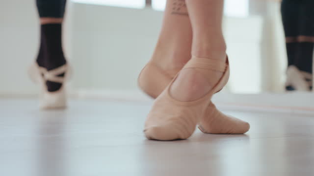 Feet of Ballet Dancers Rehearsing in Studio
