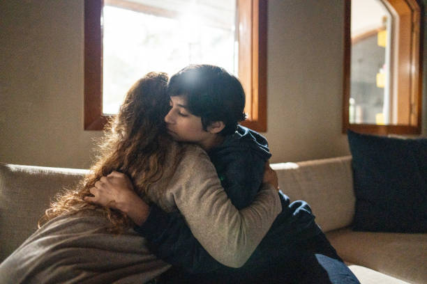 istock Mother and son embracing at home 1682581641