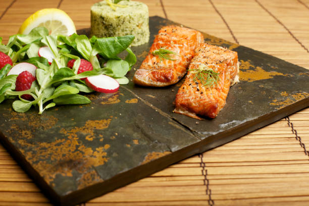 istock Slate tile plated grilled wild Salmon fillet arugula and couscous 168258176
