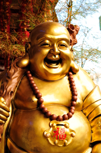 Laughing Buddha Donation Box. Picture taken at a Buddhist Temple in Singapore.