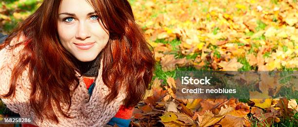 Woman With Red Hair Laying On Autumn Leaves Stock Photo - Download Image Now - Autumn, Women, Human Face