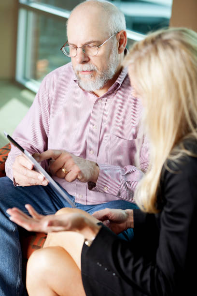istock Social worker working with senior man on digital tablet 168258479