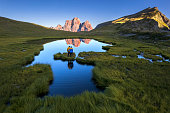 Lovers admiring the sunset over Dolomites, Italy