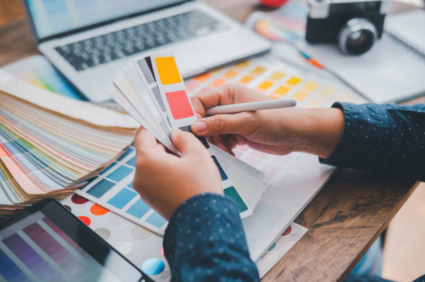 istock Graphic designer architects who work with laptops and color comparison tables for design work. 1682585037