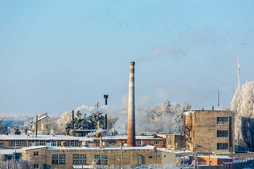 The smoky chimneys of the factory pollute the environment. In winter, smoke comes from the company's chimney.
