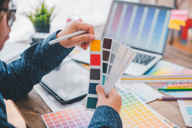 istock Graphic designer architects who work with laptops and color comparison tables for design work. 1682589016