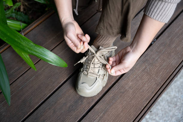istock A woman is tying shoelaces 1682591694