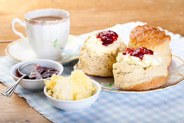 English Cream Tea Traditional scones, cream and jam served with a cup of tea scone photos stock pictures, royalty-free photos & images