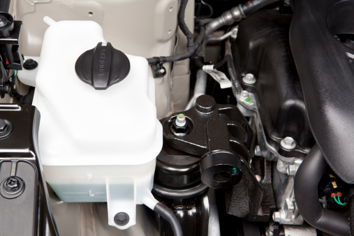 Automotive engine coolant tank, provides an overflow and reservoir for the engines radiator antifreeze solution.