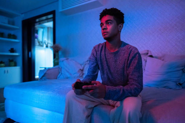 istock Young man playing video game at home 1682597870