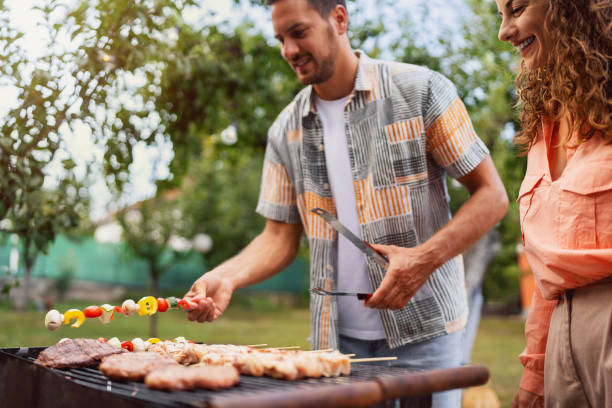istock Young Caucasian couple making barbecue 1682598397