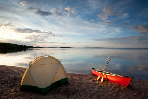 Camping, at Prince Albert National park, Saskatchewan, Canada, Waskesiu Lake,canoe with clouds rolling in.