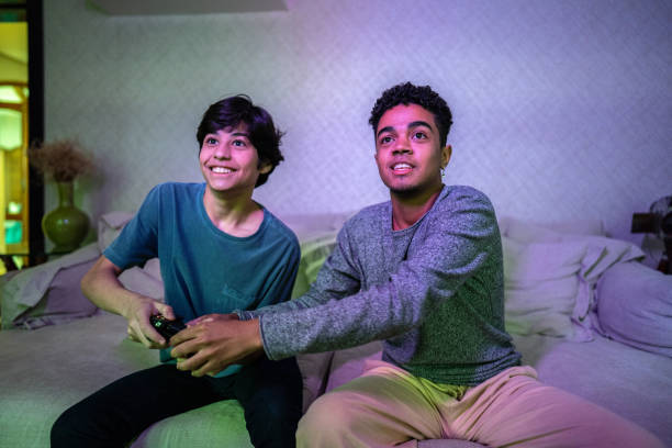 istock Brothers playing video game at home 1682598959
