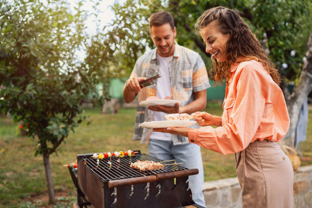 istock Young Caucasian couple making barbecue 1682598961