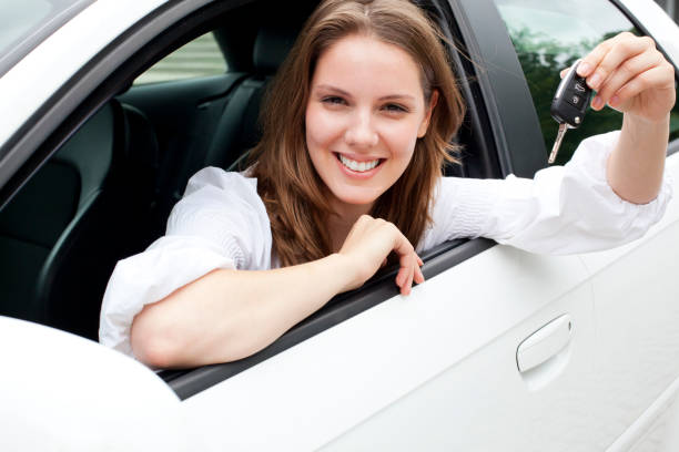 istock Young woman showing new car keys 168260352